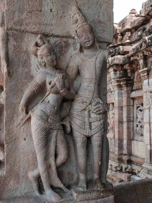 Intricate stone sculptures at Pattadakal temple, India showcasing historical artistry.